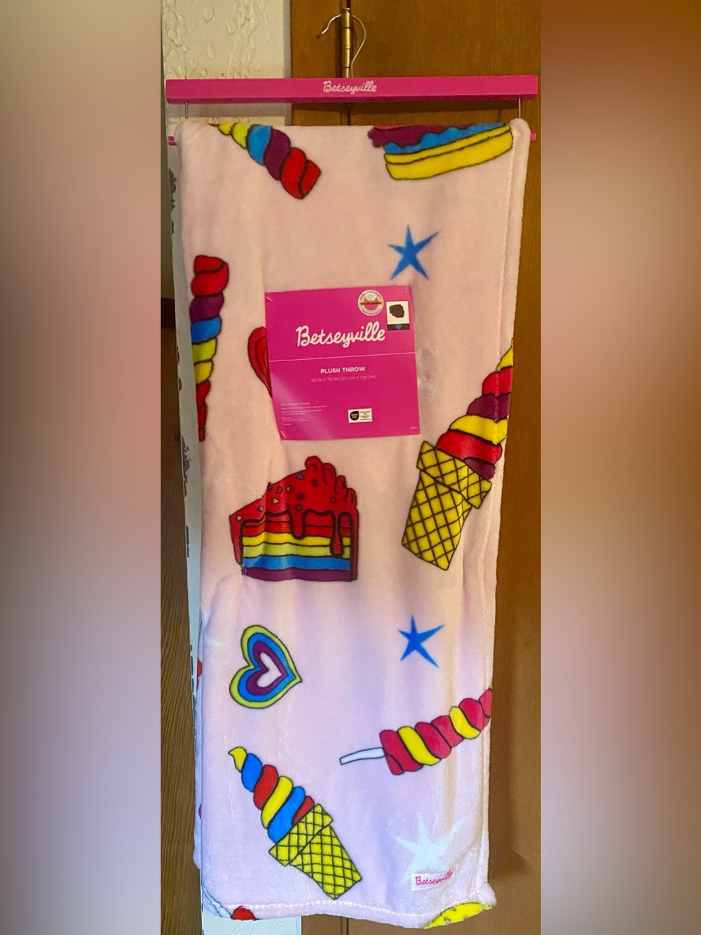 Betseyville “Cake” plush throw blanket vibrant pink background colorful graphics